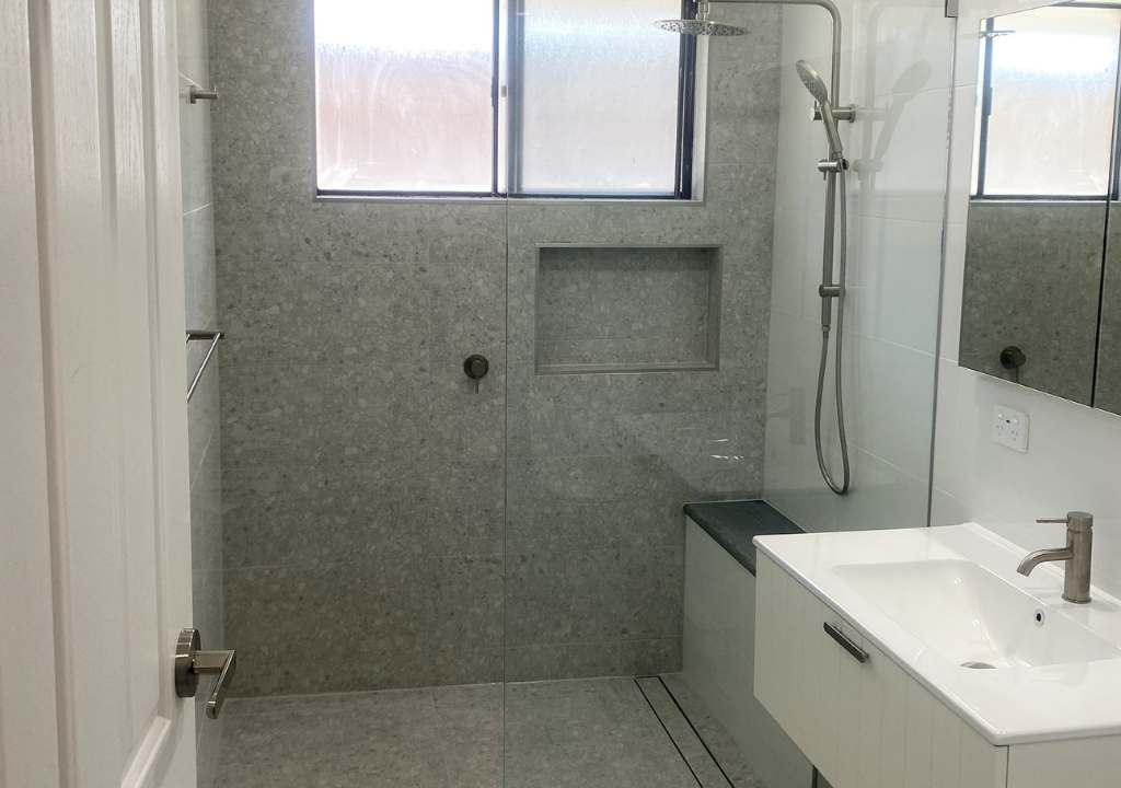 Modern Sydney bathroom renovation by Empire Tiles with warm grey tiles
